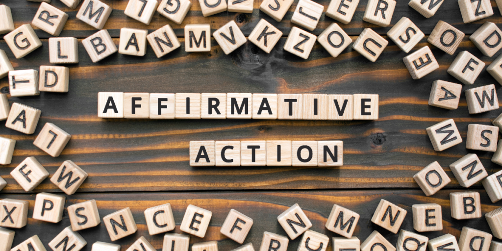 Wooden letter blocks spell out Affirmative Action on a dark wooden surface, surrounded by scattered alphabet blocks, highlighting the challenge faced by Black and Brown students today.