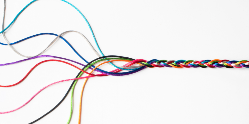 Several colorful strings are intertwined into a single, tightly braided cord, symbolizing bridges and pathways, with loose ends spreading out on the left side against a white background.